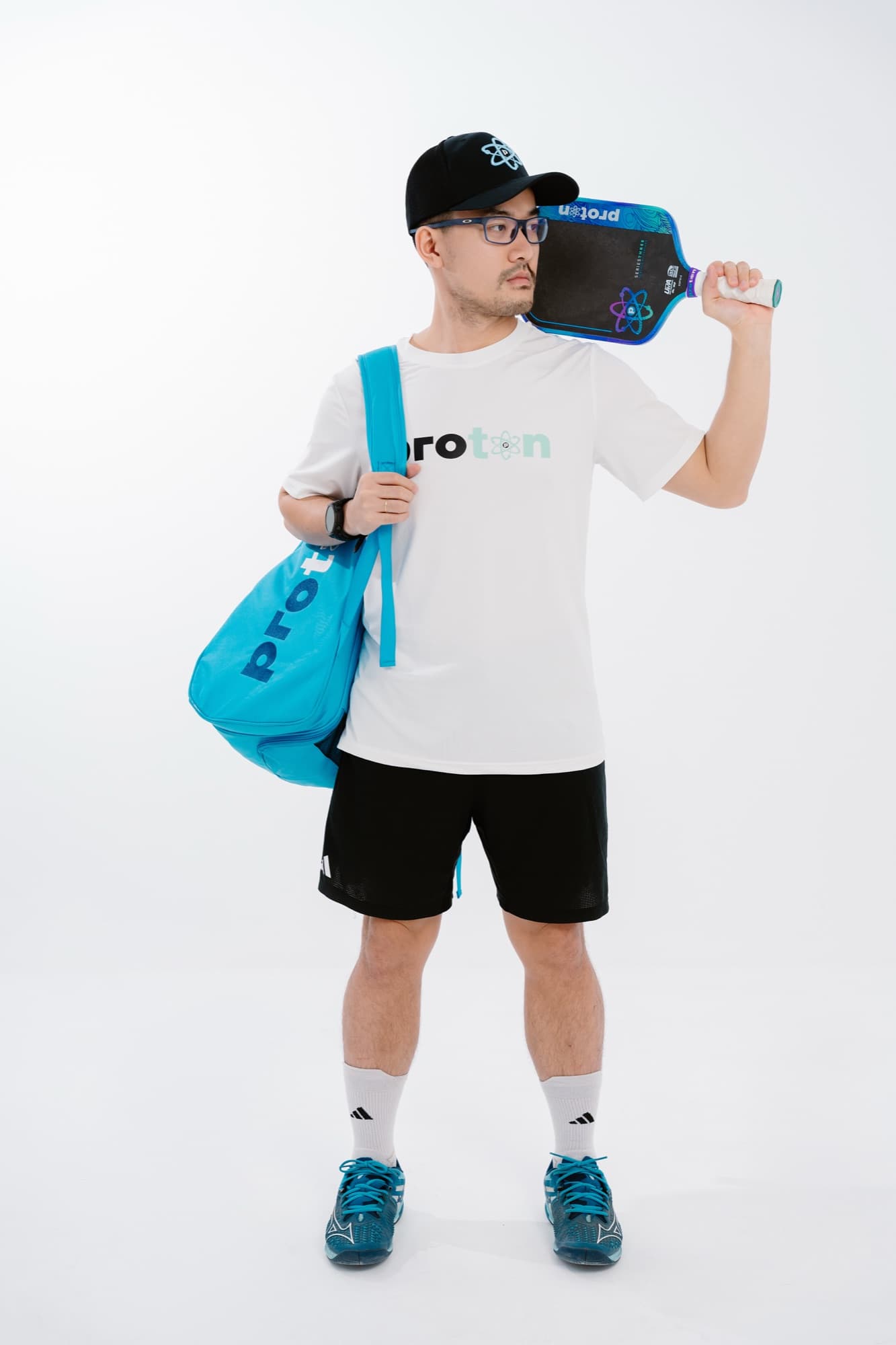 Coach Ho carrying a Proton pickleball bag and paddle